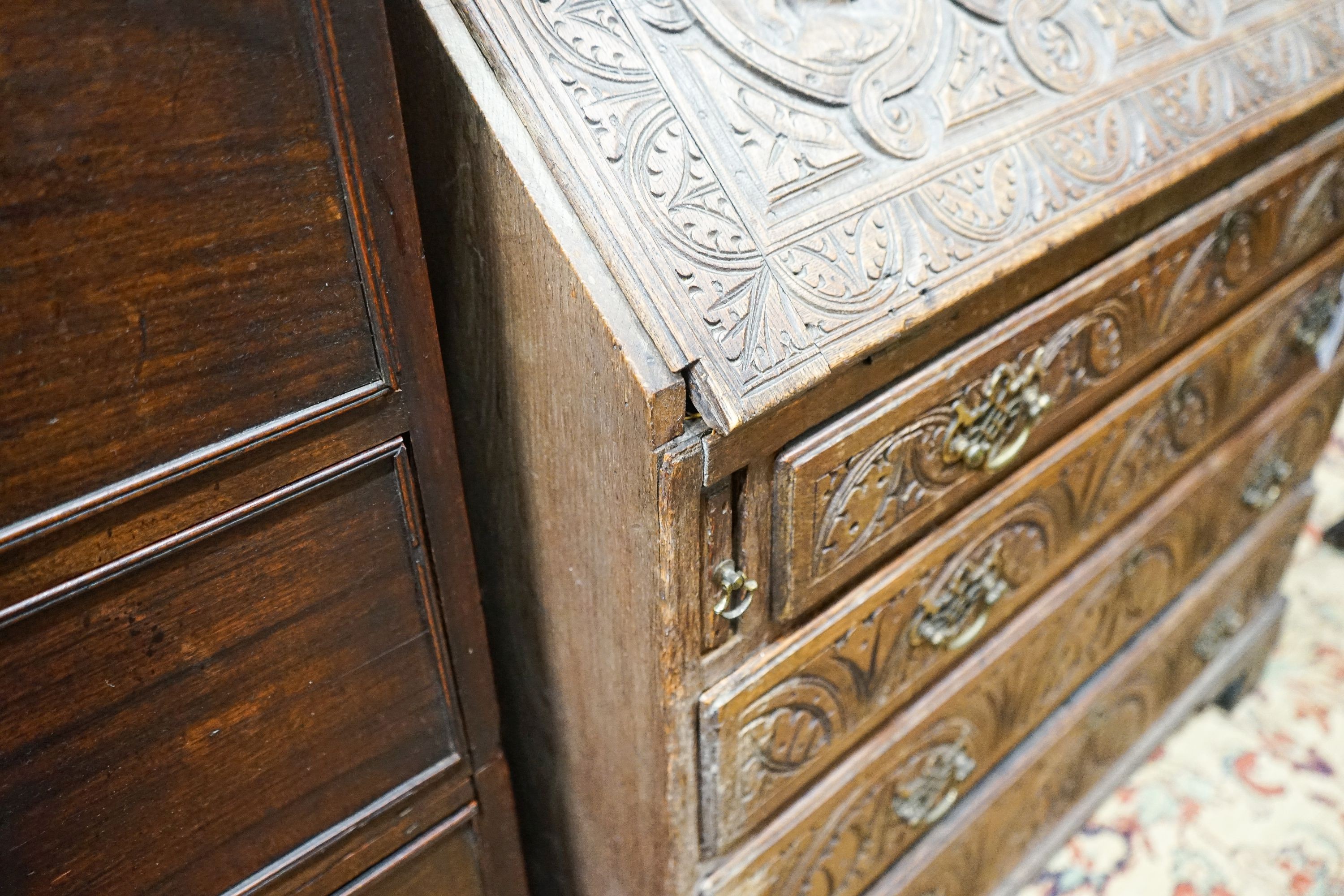 A George III later carved oak bureau, width 91cm, depth 50cm, height 106cm